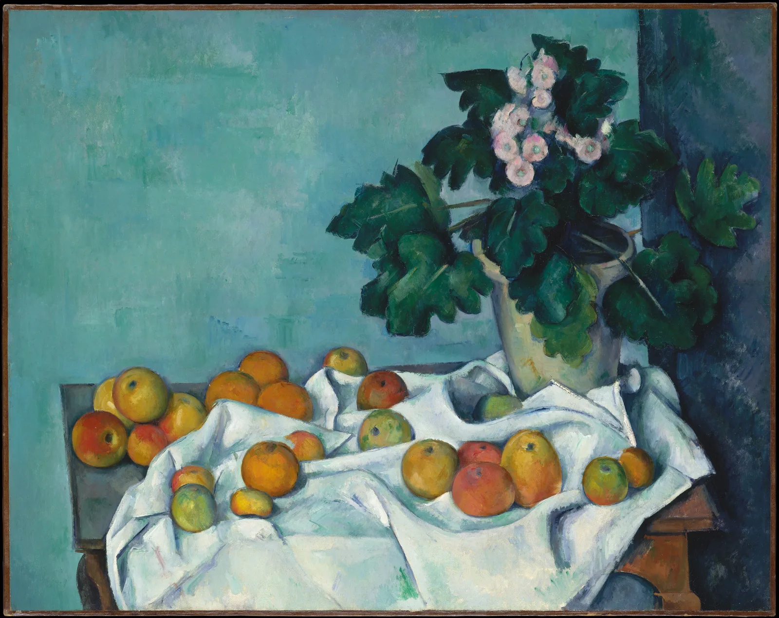 Paul Cézanne, Still Life with Apples and a Pot of Primroses: a white cloth spreads over a table in front of a blue-green wall, with red and yellow apples scattered on it and on the bare tabletop at left. At right is a pot of primroses with pink flowers and dark green leaves. A broad blue-grey tabletop shows at left; at right, a red-brown table edge and a scalloped apron.
