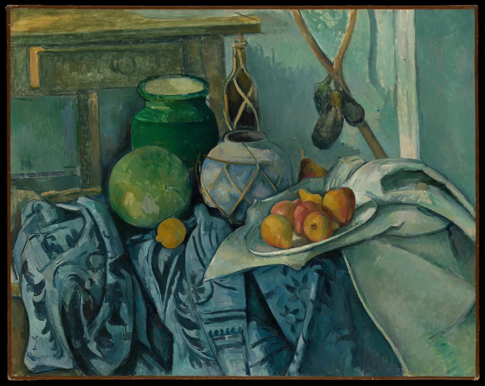 Paul Cézanne, Still Life with a Ginger Jar and Eggplants: blue patterned cloth and a white cloth cover the lower part of the picture, holding a green melon, a lemon, a ginger jar wrapped in cord, a green jar, and a white plate of fruit. Two eggplants hang at upper right, and part of a piece of furniture shows at upper left. No table edge is visible.