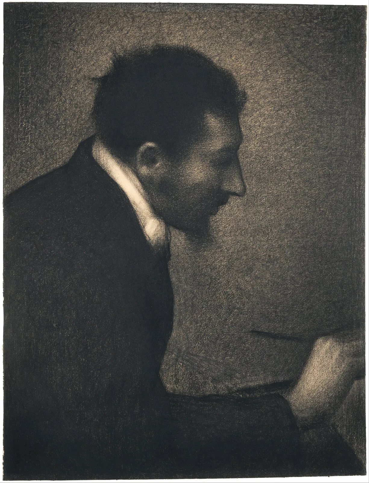 Seurat's conté crayon drawing Aman-Jean. A man in a black coat is seen in profile facing right, his head slightly bowed. A white shirt collar glows around his neck, and his forehead, nose ridge and ear rise as greys. The edge of the profile has no line: the grey face simply meets a slightly lighter grey-brown background. At lower right, a light hand holds a thin stick drawn as a single dark horizontal stroke. The grain of the paper shows evenly across the sheet.