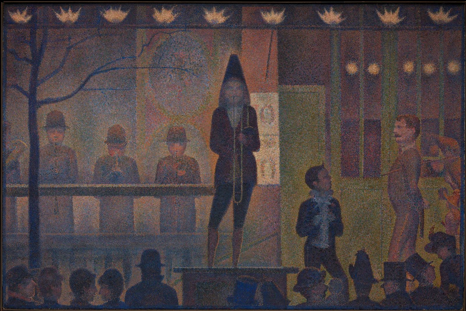Seurat's painting Circus Sideshow. The whole wide picture is covered with small dots of violet, orange, green and blue. In the centre a trombonist in a conical hat stands on a dais facing us; on the left four musicians in round hats stand in a row behind a railing. On the right a tall man with a moustache and a clown with a ruffled collar face each other. Along the top runs a row of nine flower-shaped gas lights, and on the left a bare tree spreads thin blue branches. Along the bottom, the heads and hats of onlookers form a row of dark silhouettes.